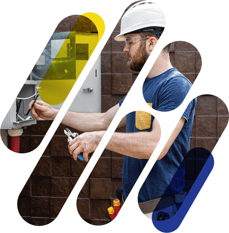 electrician in hardhat and googles performing maintenance on fuse box